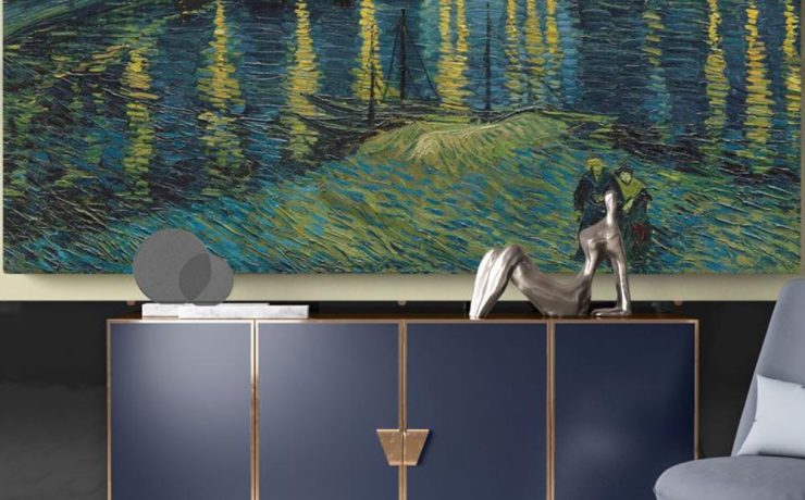 Elegant interior with navy cabinet and sculpture, featuring Van Gogh’s Starry Night painting of a starlit river scene on wall.