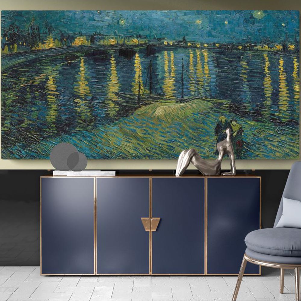 Elegant interior with navy cabinet and sculpture, featuring Van Gogh’s Starry Night painting of a starlit river scene on wall.