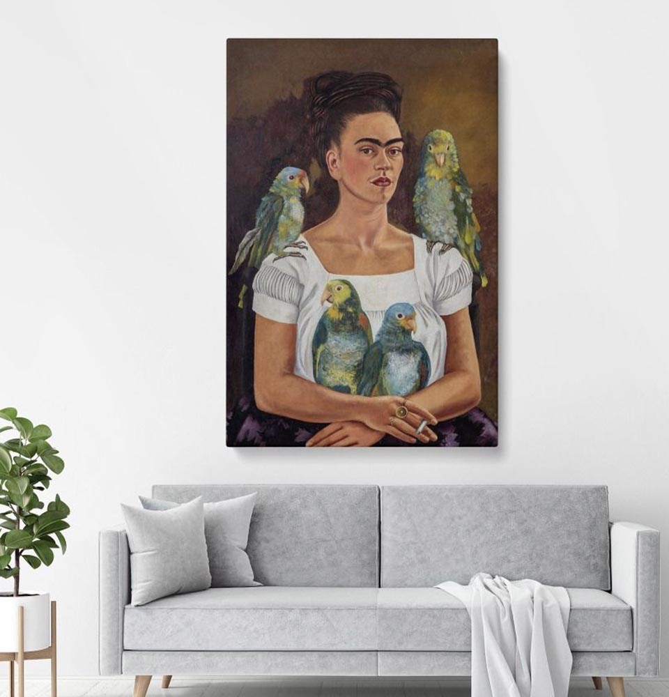 minimalist-living-room-with-grey-sofa-and-plant-featuring-colorful-frida-kahlo-wall-art-portrait-with-parrots-above-couch Minimalist living room with grey sofa and plant, featuring colorful Frida Kahlo Wall Art portrait with parrots above couch.