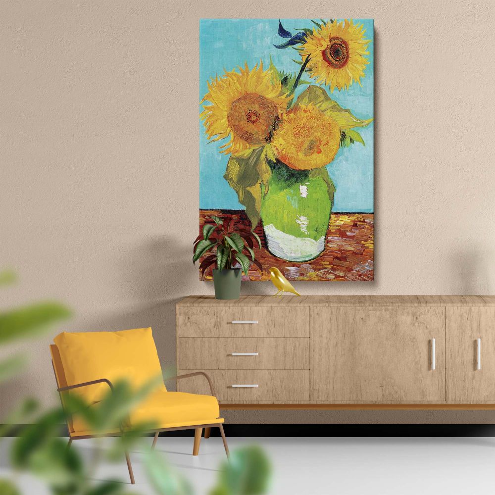 This is Vincent van Gogh's 1888 painting Vase with Three Sunflowers, presenting three lively yellow sunflowers arranged in a green vase on a wooden table, complemented by a soft blue backdrop, radiating a sense of warmth and artistry.