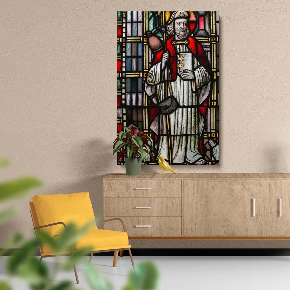 Traditional stained glass window showcasing a saint dressed in red and white robes holding a staff and book, accompanied by a kneeling worshiper, set within vibrant geometric patterns and radiant Gothic-style stained glass artistry in a church setting.