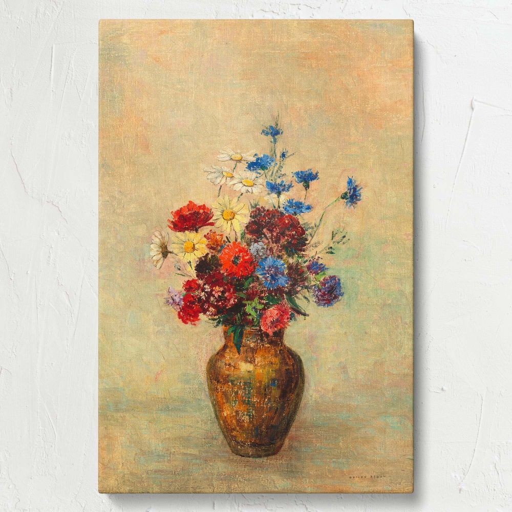Odilon Redon's Flowers in a Vase (1910) presents a harmonious blend of vibrant floral colors in shades of red, blue, and yellow nestled in an earthen vase, contrasted beautifully against a soft pastel background in an impressionist style.
