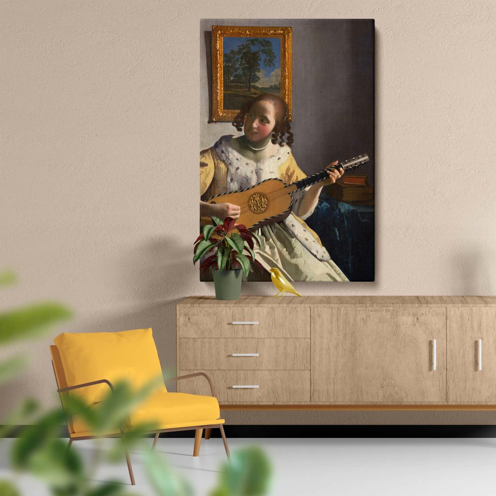 Artistic reproduction of The Guitar Player by Vermeer as a wall canvas, showcasing a beautifully lit interior with a woman in a yellow dress playing a guitar, surrounded by elegant furnishings, a framed painting, and soft shadows adding depth.