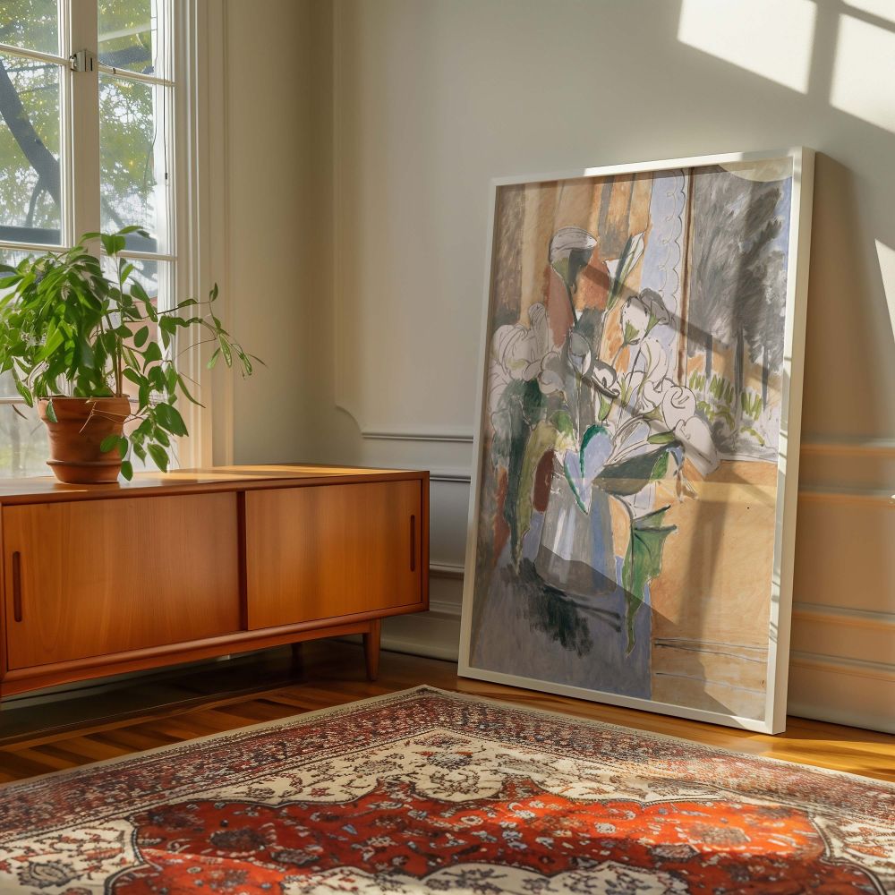 Modern floral wall canvas of a Henri Matisse painting featuring stylized calla lilies in a vase with bold green and white strokes. Placed on a cool-toned blue table beside an ochre wall and veranda scene, the bouquet takes center stage. The flowing lines 