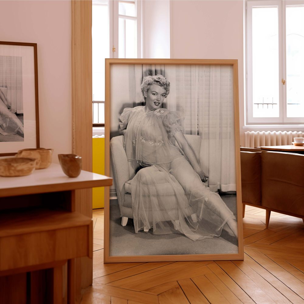 Stunning black and white wall art of Marilyn Monroe in a flowing sheer dress showing her relaxed pose and glowing smile iconic of retro glamour photography and perfect for those who admire elegant woman decor and timeless celebrity style.