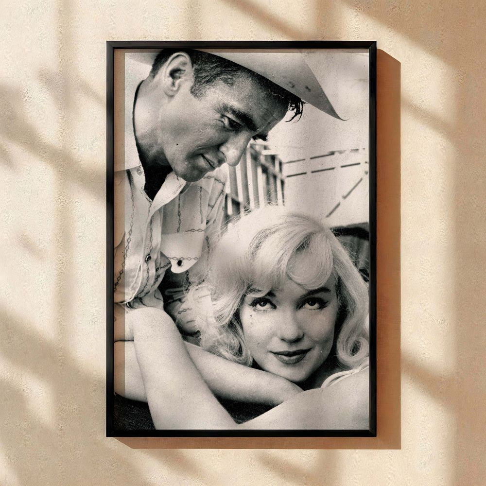 Marilyn Monroe in a calm pose with a man in a cowboy hat looking at her in admiration this vintage photograph captures old Hollywood romance and makes for a beautiful emotional wall art piece for Monroe collectors and fans of cinematic photography.
