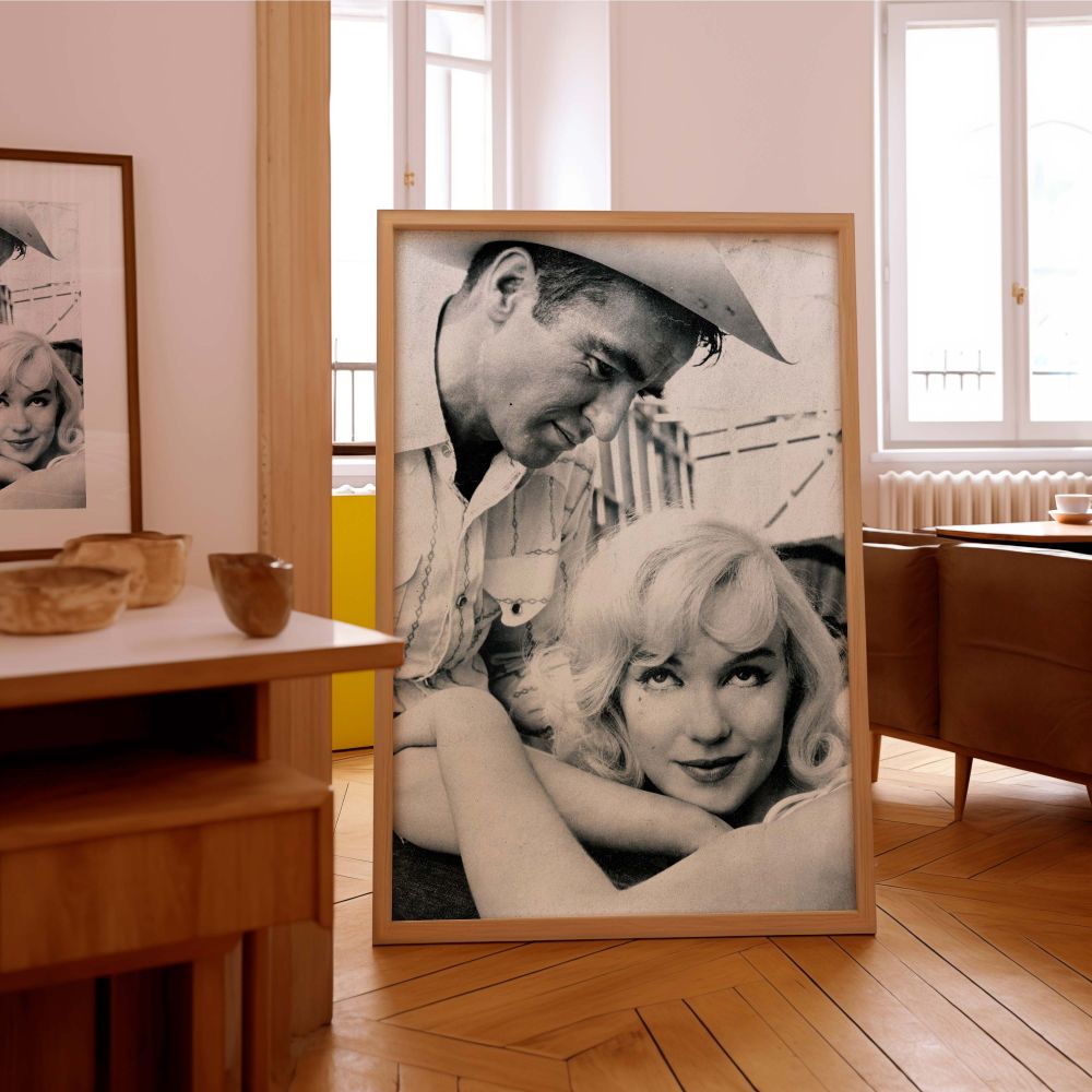A beautifully composed photograph of Marilyn Monroe looking relaxed while being gazed at by a man in a cowboy hat this black and white image is a timeless piece of emotional wall decor for fans of romantic vintage portraits and classic star elegance.