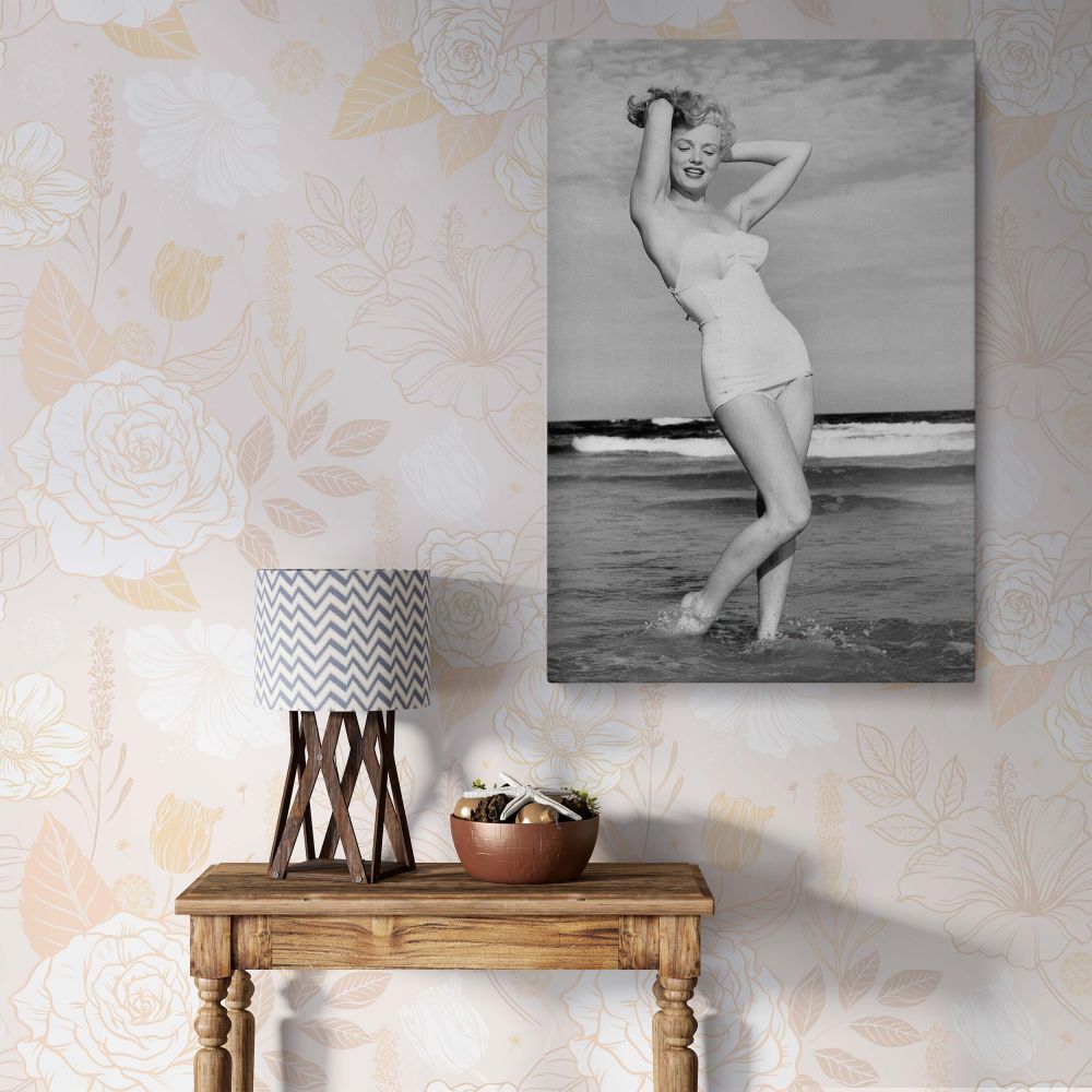A black and white canvas image of Marilyn Monroe posing gracefully on a beach in a vintage bikini, perfect for bedroom or living room wall decor.