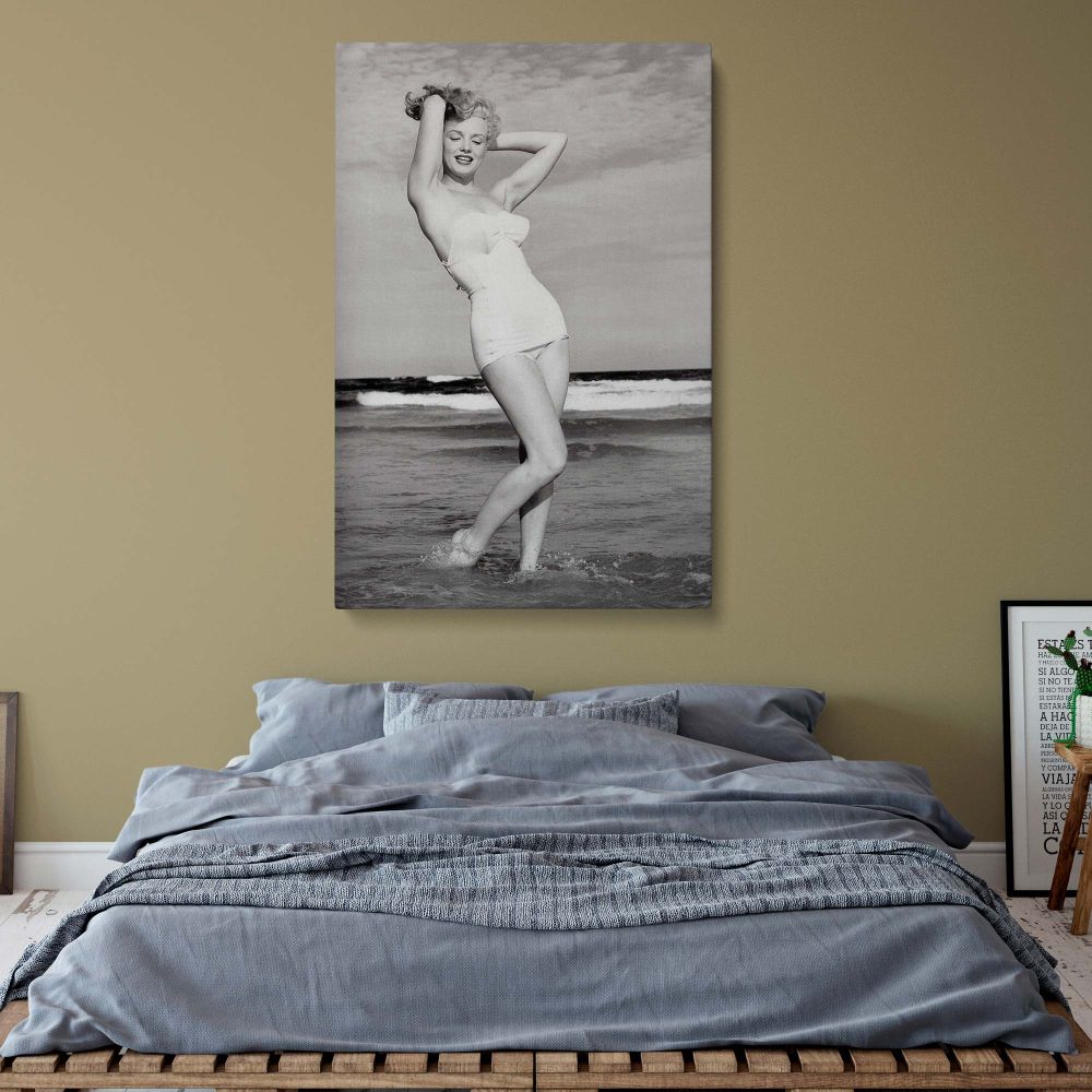 Classic Hollywood wall decor of Marilyn Monroe posing in waves, captured in high-definition black and white for a nostalgic home accent.