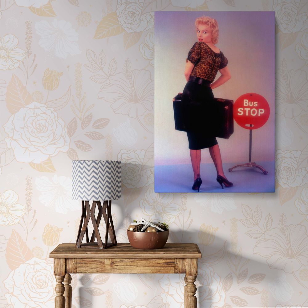 Marilyn Monroe in Bus Stop photo canvas wall art featuring her in a vintage lace blouse and pencil skirt standing next to a red Bus Stop sign