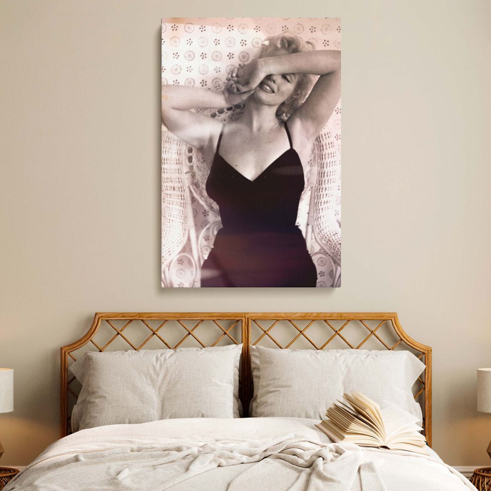 High-quality wall art of Marilyn Monroe in classic Hollywood glamour style, sitting against vintage wallpaper and retro wicker chair.