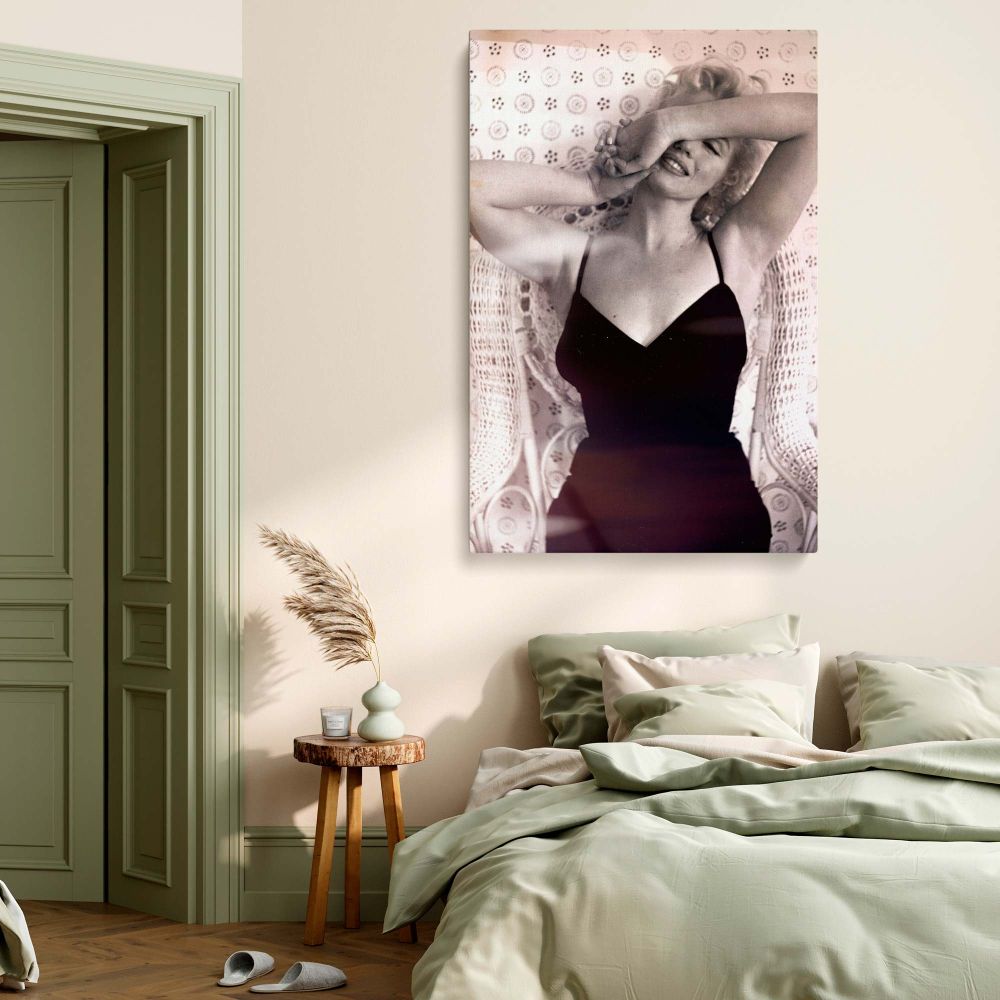 Marilyn Monroe wall art with black dress and vintage wicker setting, adding timeless elegance to boudoir or Hollywood-themed rooms.