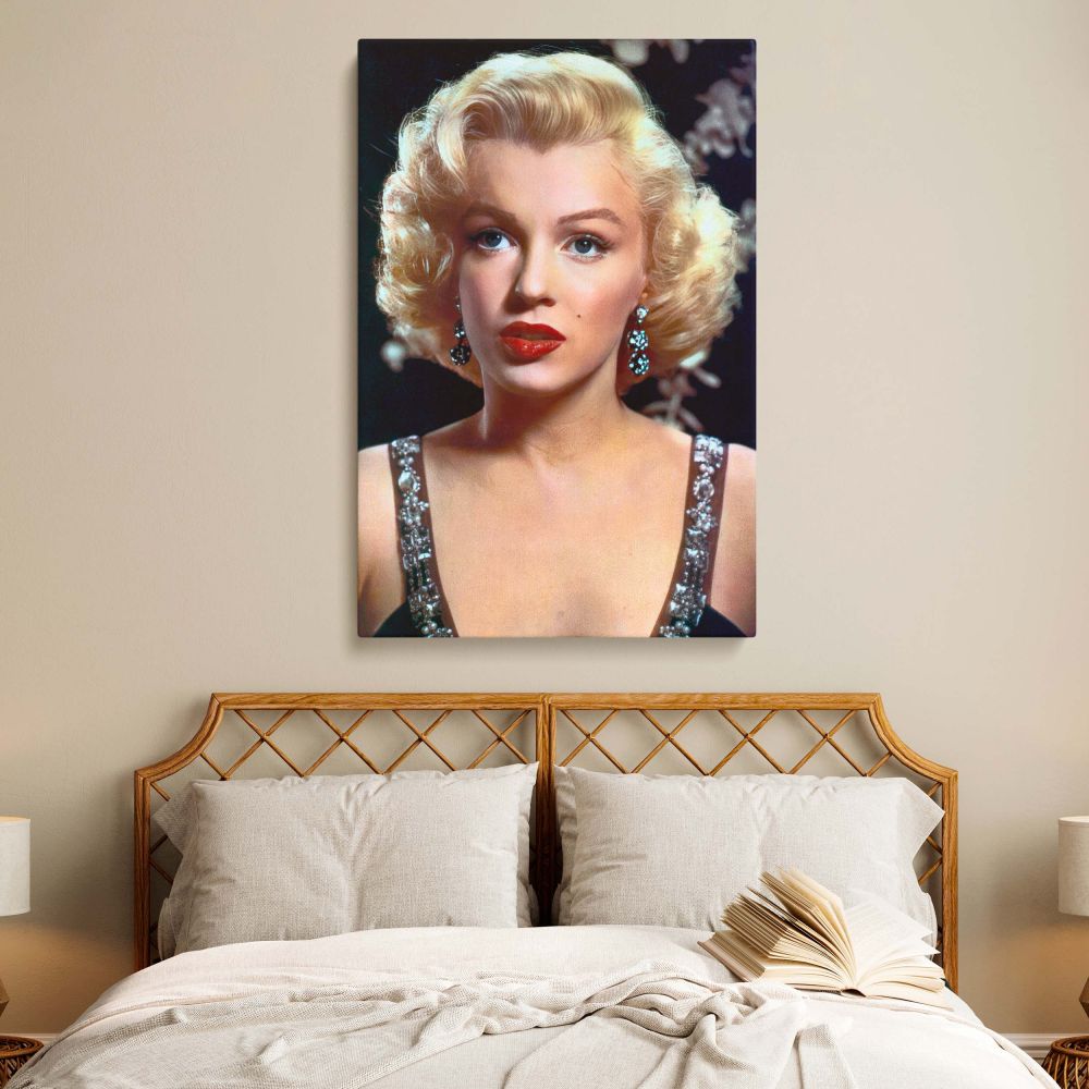 Marilyn Monroe shines in this glamorous close up portrait that immortalizes her vintage Hollywood appeal. Her soft curls, red lipstick, and elegant earrings come to life in this restored vintage Hollywood photo canvas. This piece celebrates not only Monro