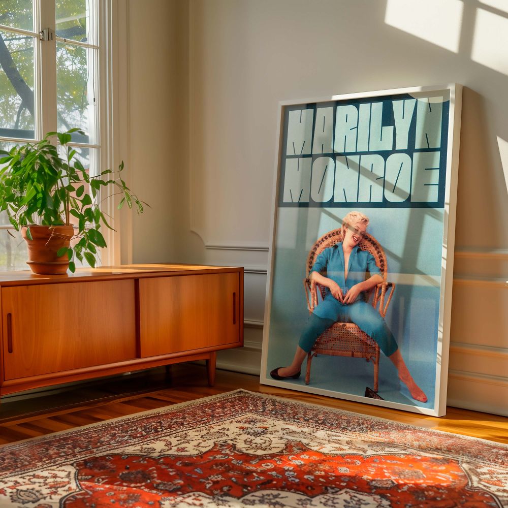This candid Marilyn Monroe blue jumpsuit art shows the screen legend at ease and smiling brightly making it a lively and iconic addition to any room inspired by vintage aesthetics classic stars or 1950s pop culture.