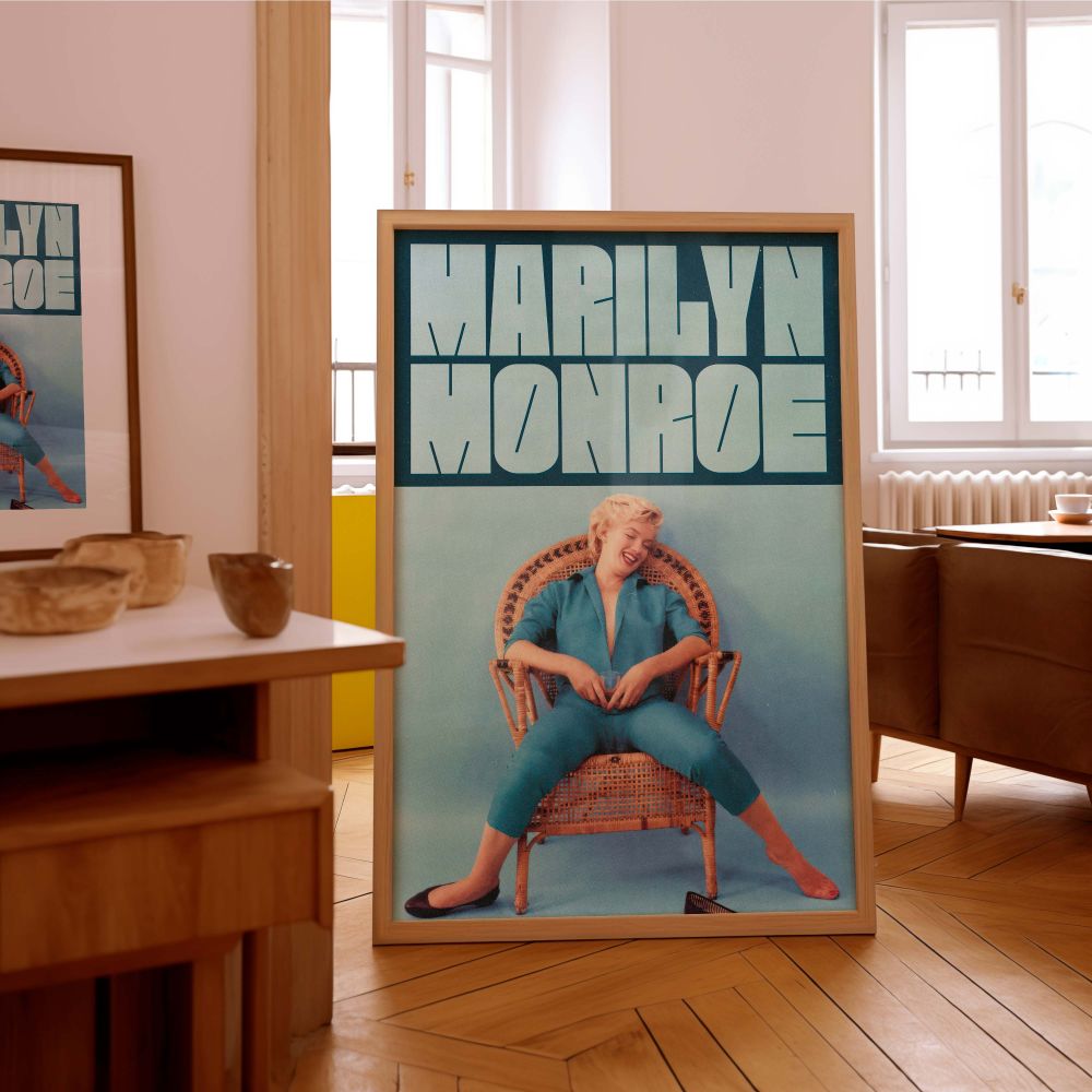 Celebrate iconic beauty with this Marilyn Monroe photo art print of her sitting playfully in a blue jumpsuit relaxed and radiant offering a refreshing glimpse of vintage Hollywood elegance and natural charm.