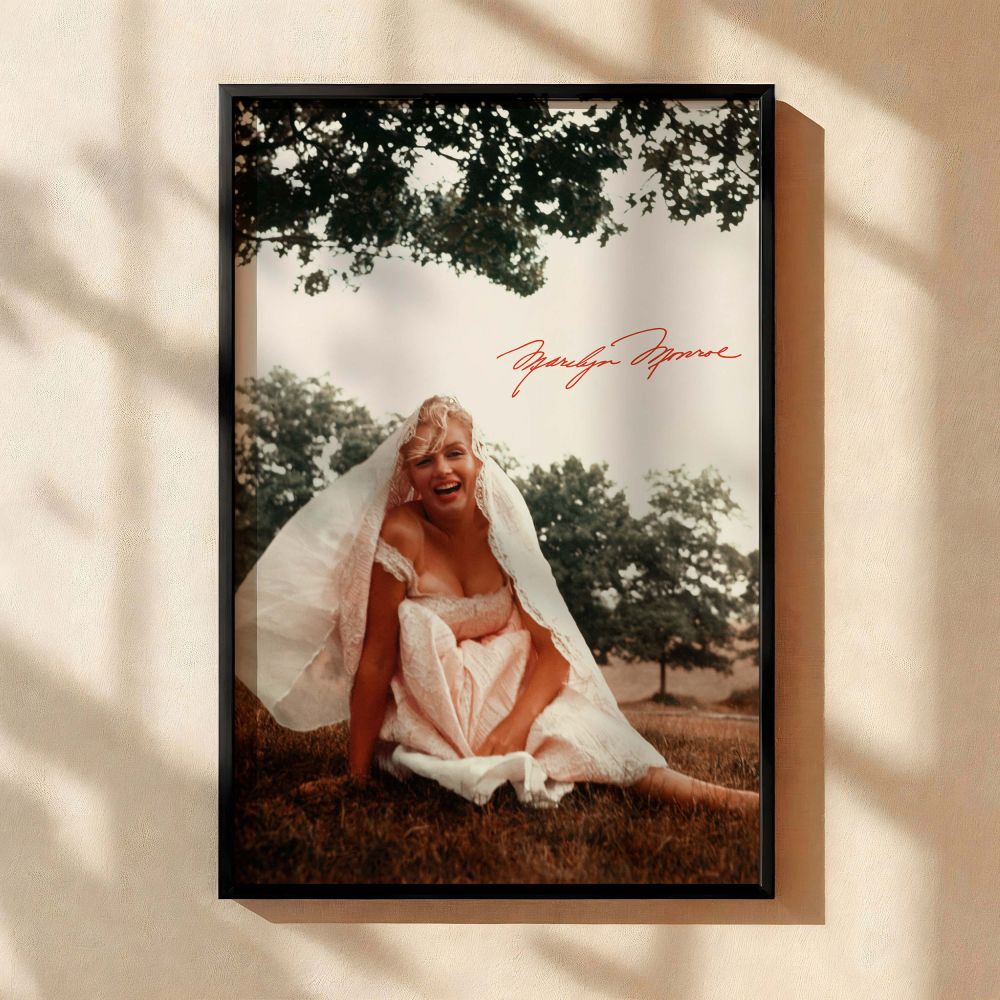 A vibrant and romantic portrait of Marilyn Monroe sitting in a vintage white gown smiling under tree shade perfect for lovers of old movie prints vintage photography fans and those who admire timeless beauty for their retro or romantic home decor themes.