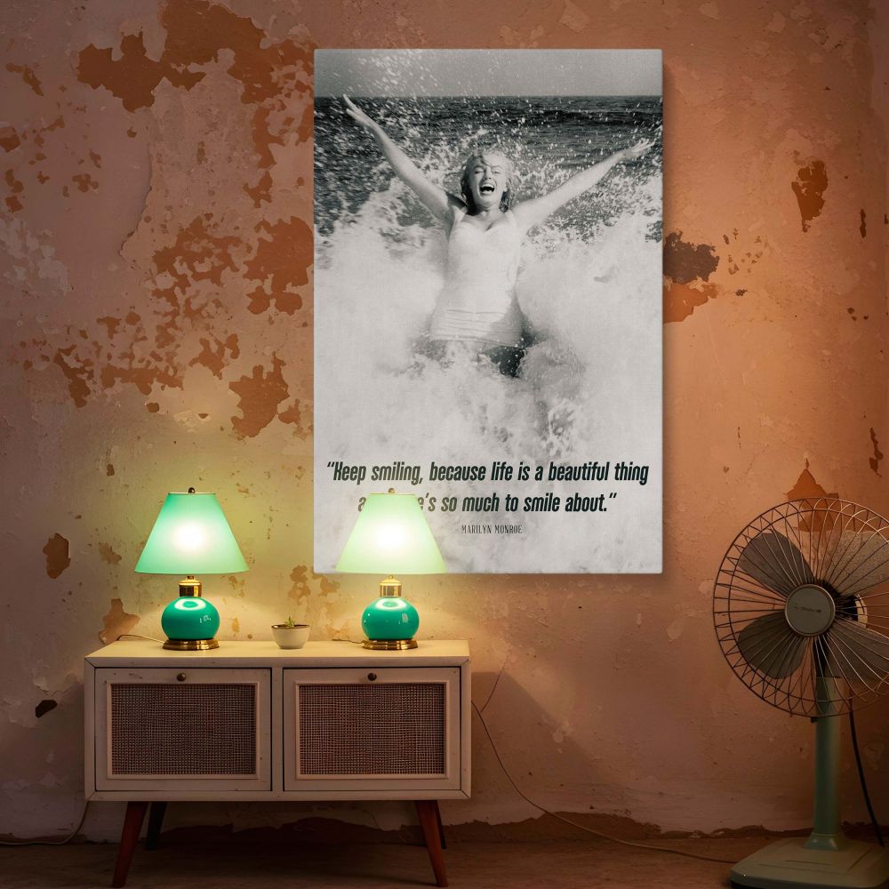Joyful black and white photo of Marilyn Monroe in the sea with her arms up and a wide smile with her uplifting quote below offering a cheerful reminder for positive thinking and retro beach aesthetic wall decoration.