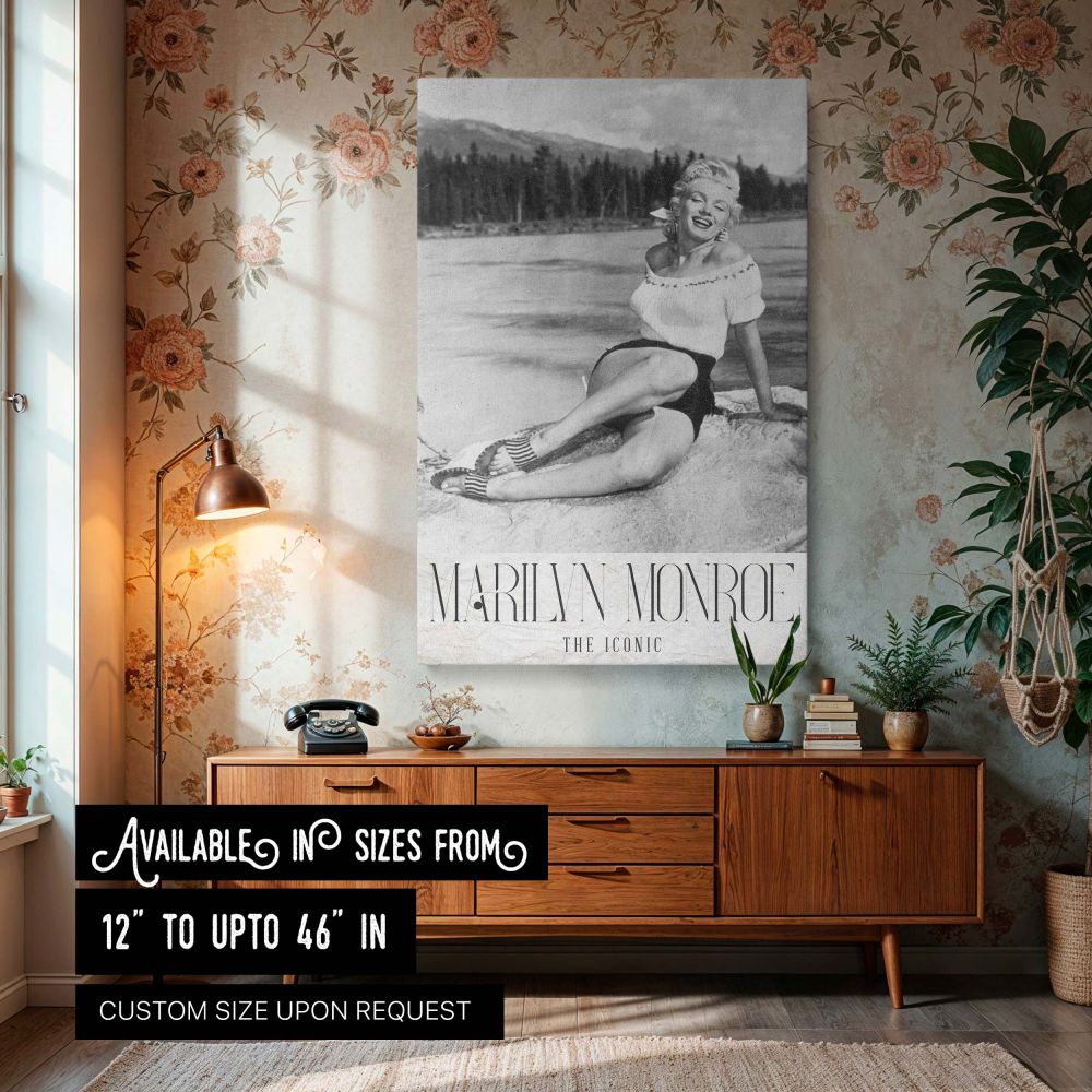 Vintage black and white wall art print of Marilyn Monroe sitting at a lakeside with mountains and trees in the background captures her classic charm and timeless glamour perfect for Hollywood collectors and retro home decor featuring Monroe's joyful expre