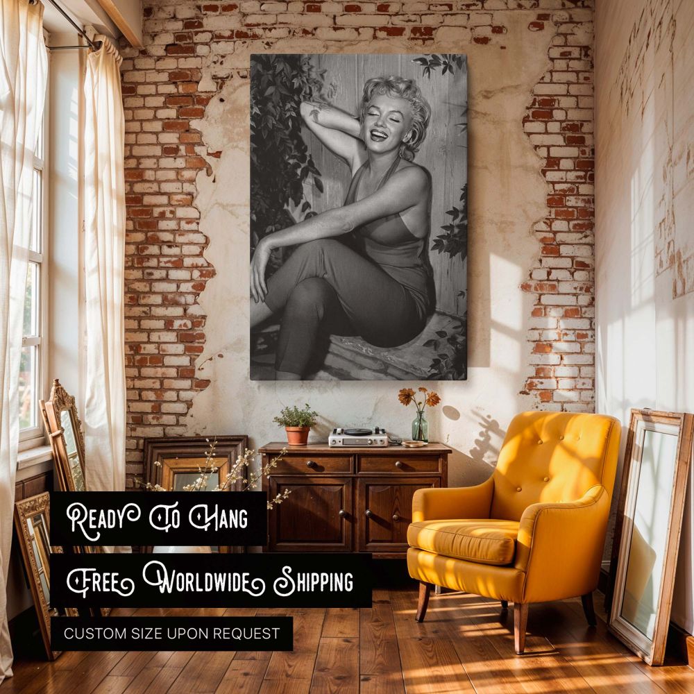 This Marilyn Monroe vintage photo shows the actress smiling brightly in a seated pose dressed in a red halter jumpsuit perfect for black and white Hollywood decor old film photography lovers and collectors of retro movie star portraits.