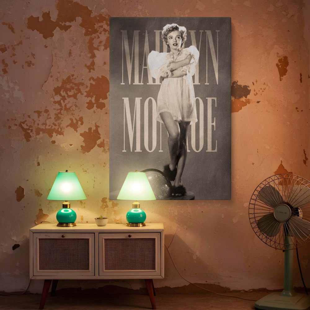 Stunning black and white photo print of Marilyn Monroe with classic curls wearing a sheer dress as she poses with one foot on a globe this elegant and symbolic portrait reflects her worldwide legacy and makes a striking home decor piece.