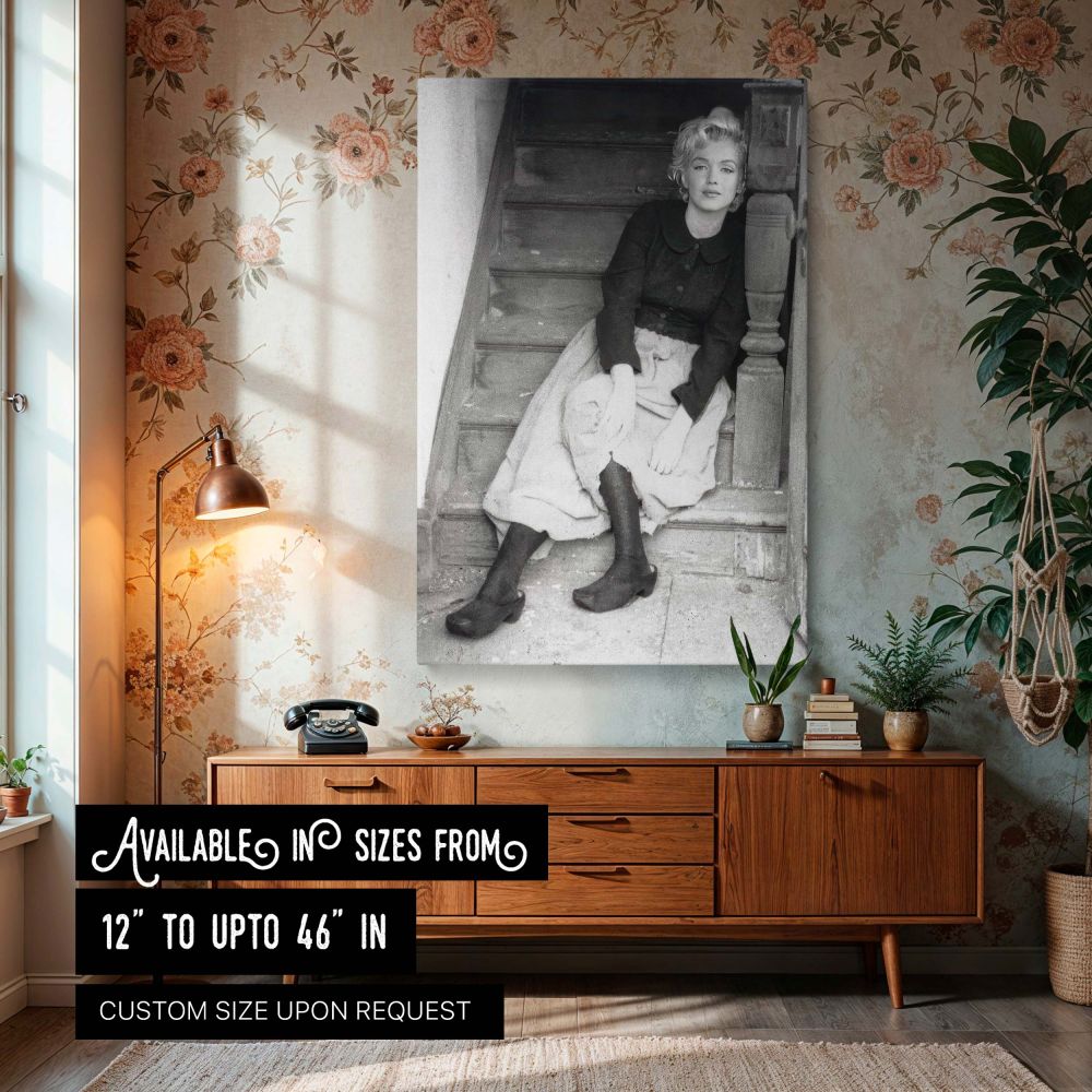 Marilyn Monroe vintage black and white photo seated on a rustic staircase wearing classic attire evokes timeless elegance making this Hollywood icon wall art a perfect retro decor piece for vintage photography lovers and classic film fans.