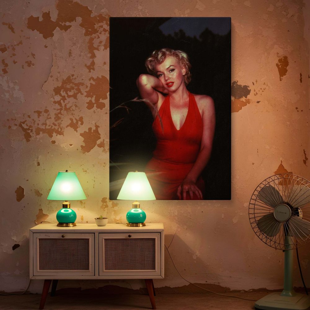 Marilyn Monroe looks breathtaking in this vintage fashion photo where she wears a form-fitting red dress the contrast of her glowing complexion against the dark scene makes this a standout piece of Hollywood wall art and the perfect addition to any retro 