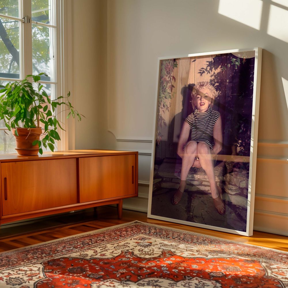 A rare photo of Marilyn Monroe in a striped turtleneck sitting quietly with a composed expression this piece of vintage wall art brings softness and grace to retro-inspired interiors and pays tribute to classic 1950s Hollywood photography with its natural