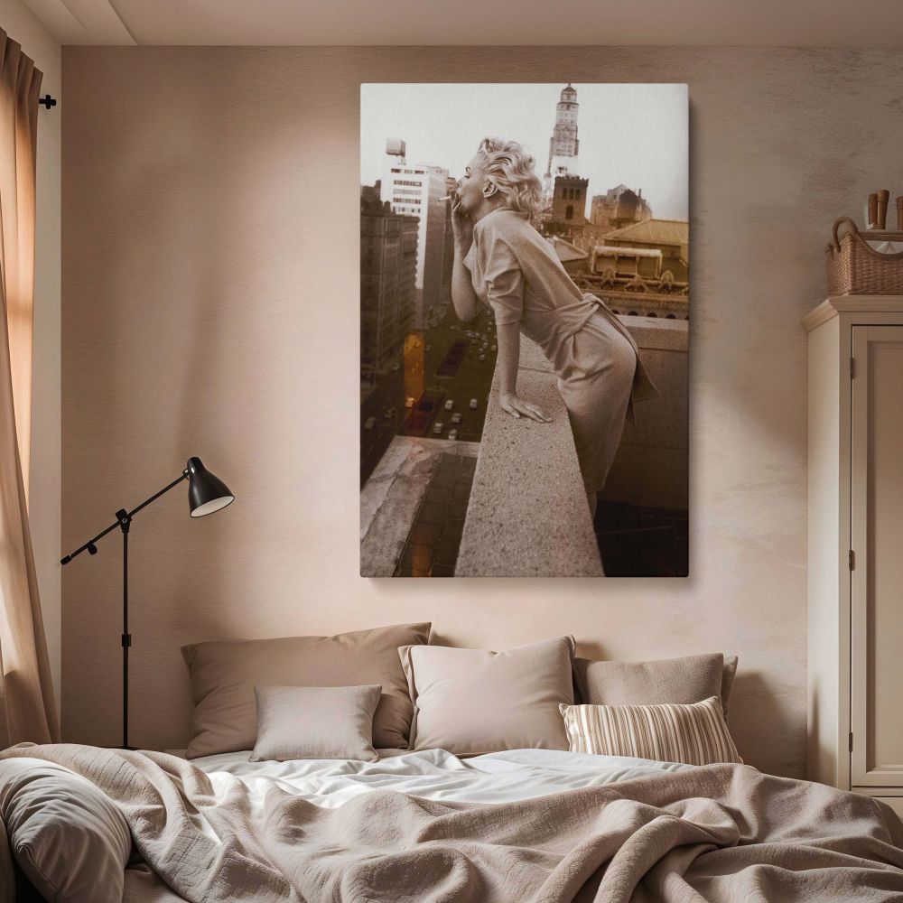 Black and white image of Marilyn Monroe leaning from rooftop sending kiss to city skyline for retro Hollywood print lovers.