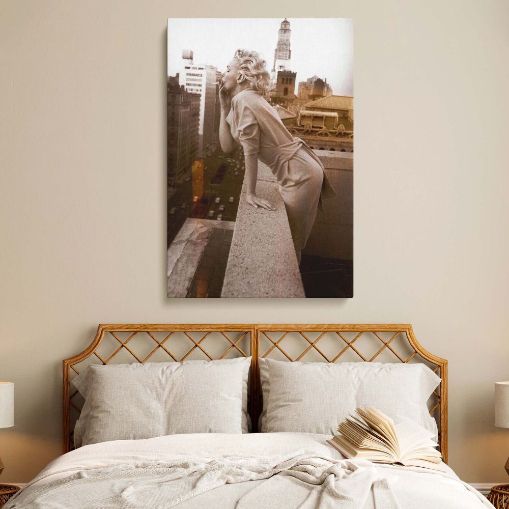 Vintage rooftop photo of Marilyn Monroe in elegant dress captured mid-kiss perfect for nostalgic and confident canvas art.