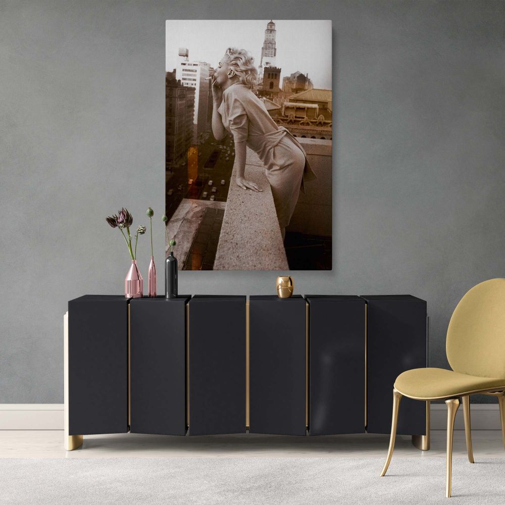 Marilyn Monroe black and white photo featuring city rooftop background and soft expression for feminine wall styling.