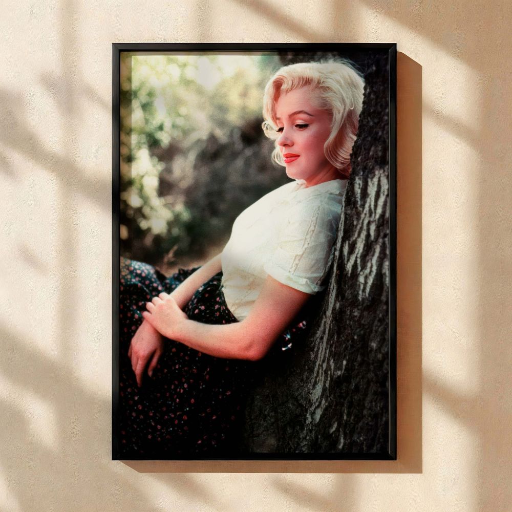 Marilyn Monroe is seen resting beneath a tree in this tranquil and elegant canvas print showcasing her gentle side and vintage fashion style making it an ideal piece of Hollywood glamour wall art and a cherished addition for collectors of iconic women in 