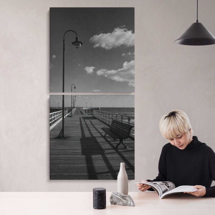 Black and white empty seaside pier with benches and lamps canvas print, interior display view