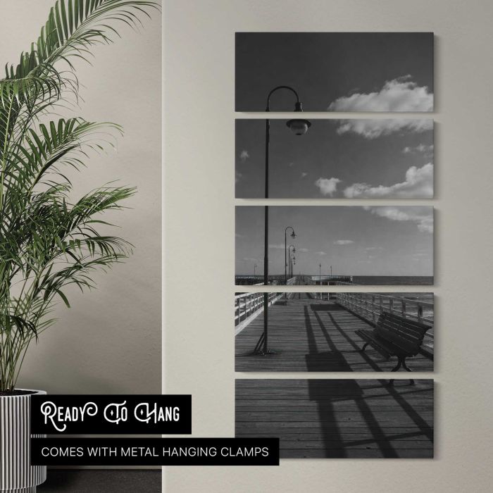 Black and white empty seaside pier with benches and lamps canvas print, interior display view
