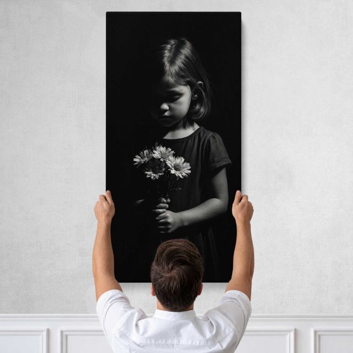 Child holding flowers in darkness canvas print, tall canvas held against a wall