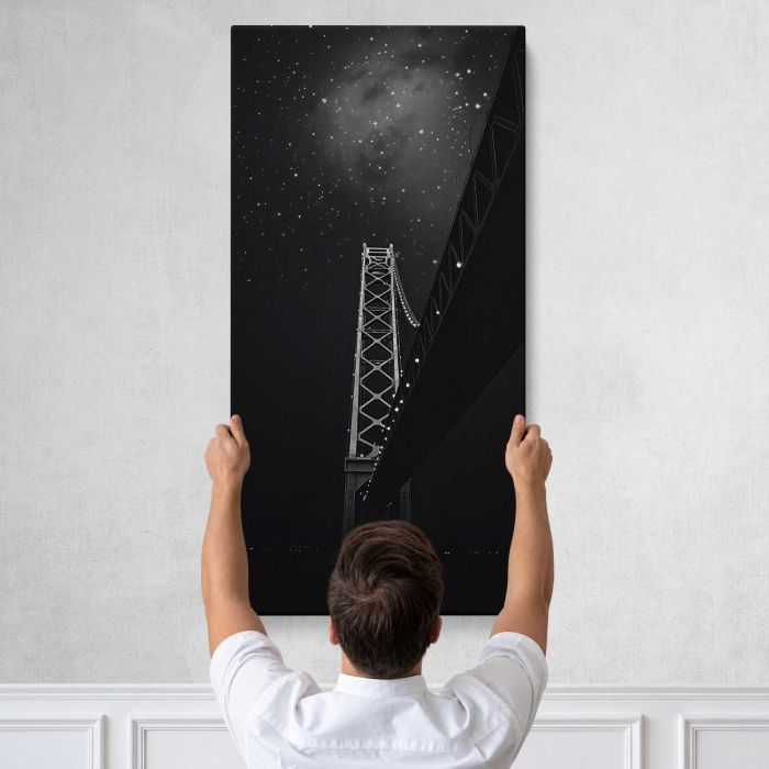 City Bridge beneath a Starry Sky canvas print, tall canvas held against a wall
