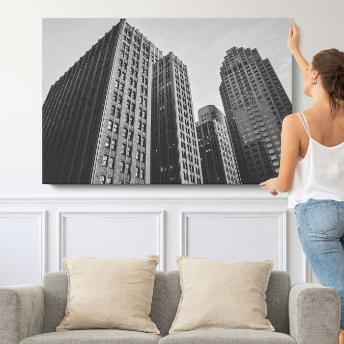 Downtown Skyscrapers in Black and White canvas print, canvas shown with a person for scale