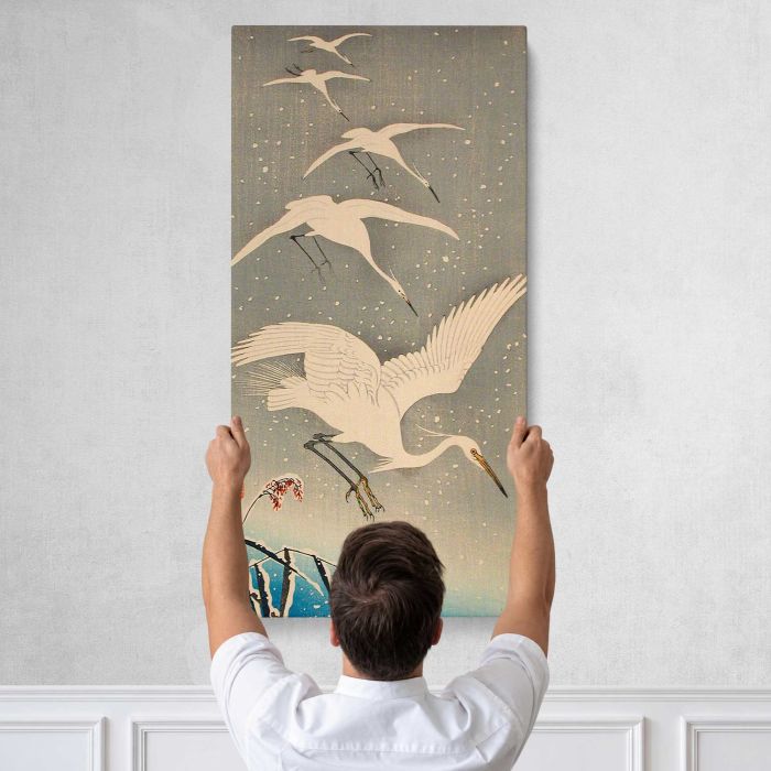 Egrets Descending in Snow by Ohara Shōson canvas print, tall canvas held against a wall