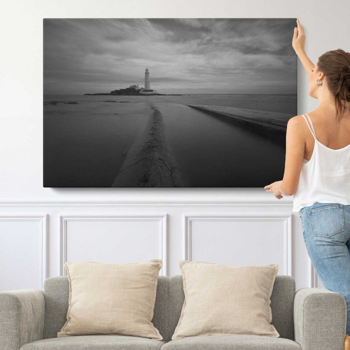 Lighthouse in black and white canvas print, canvas shown with a person for scale