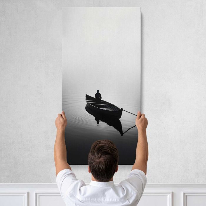 Man Fishing from a Rowboat in Monochrome canvas print, tall canvas held against a wall