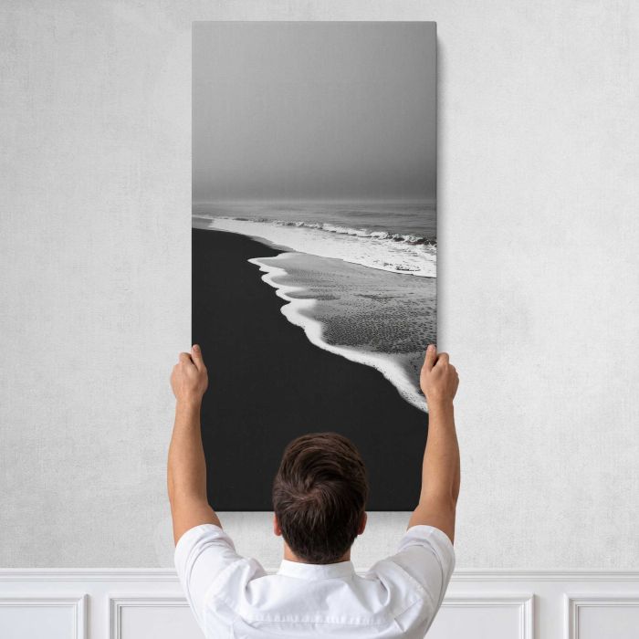 Monochrome serene beach waves canvas print, tall canvas held against a wall