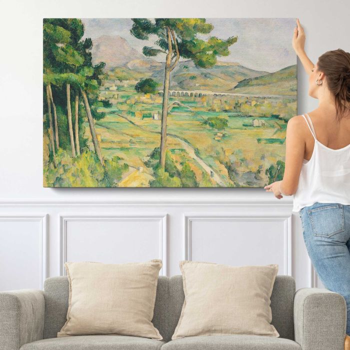 Mont Sainte-Victoire and the Viaduct of the Arc River Valley (ca. 1882–1885) by Paul Cézanne canvas print, canvas shown with a person for scale