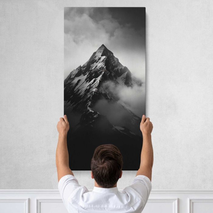 Mountain Peak above Clouds in Monochrome canvas print, tall canvas held against a wall