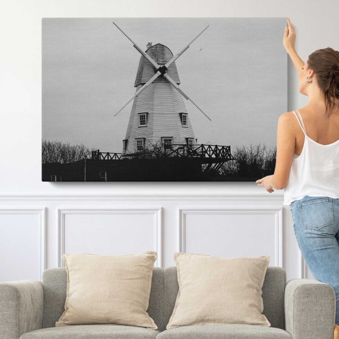 Old windmill in countryside canvas print, canvas shown with a person for scale