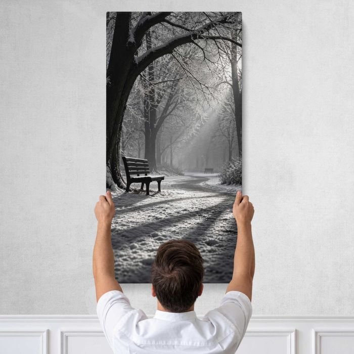 Park Bench beneath Sunlit Trees in Monochrome canvas print, tall canvas held against a wall