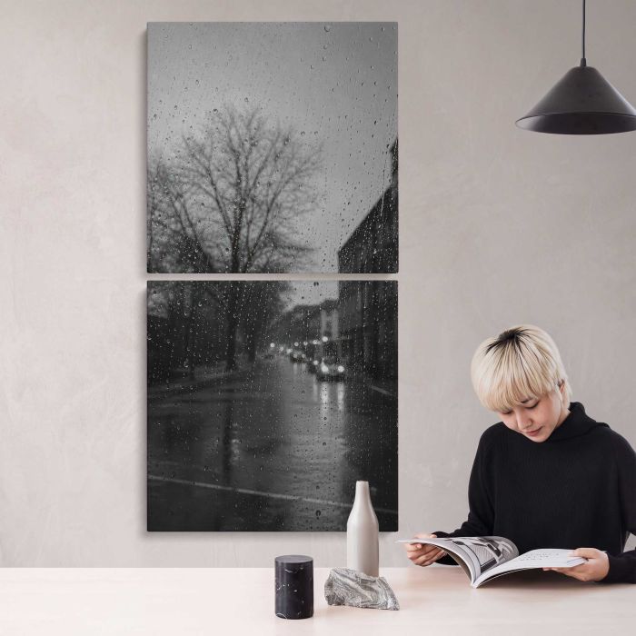 Rainy city street through window droplets, moody monochrome canvas print, interior display view