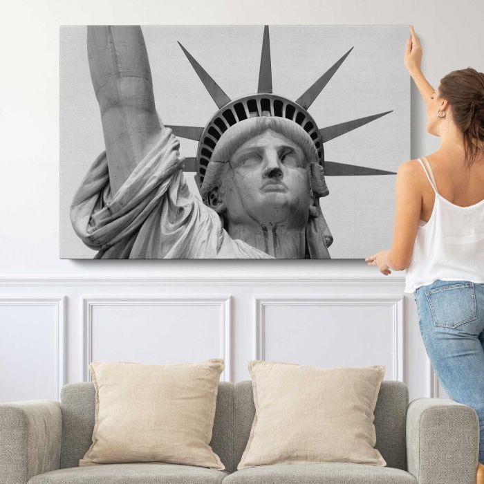 Statue of Liberty Face Close-Up in Black and White canvas print, canvas shown with a person for scale