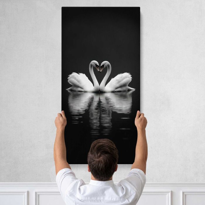 Swans Forming a Heart in Monochrome canvas print, tall canvas held against a wall