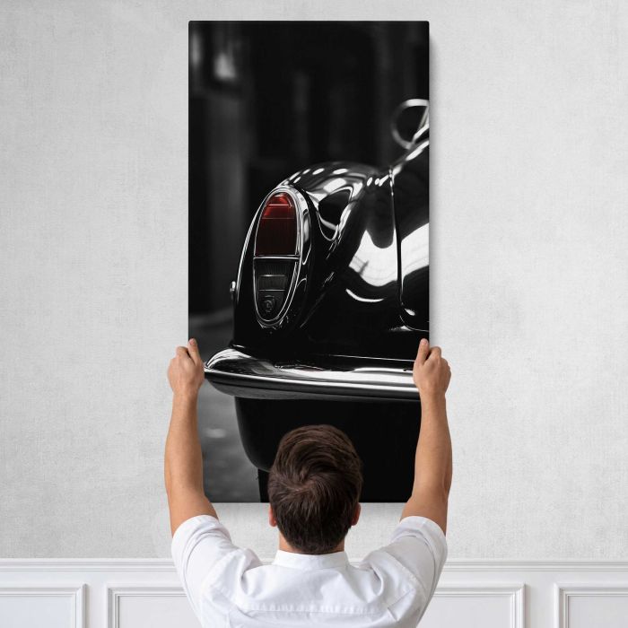 Vintage Car Headlight and Grille in Monochrome canvas print, tall canvas held against a wall