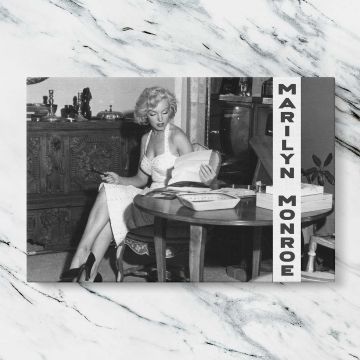 Marilyn Monroe Seated at a Table canvas artwork displayed on a marble background
