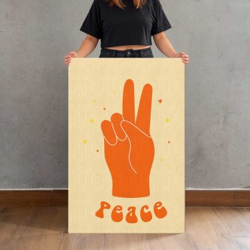 Orange Peace Hand on Yellow canvas print, held for scale